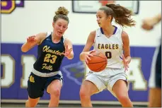  ?? MARK KEMPTON — FOR THE MORNING JOURNAL ?? Avon junior guard Abby Liber (0) pulls the ball back to prevent a steal by Olmsted Falls senior Lauren Galaska (23) on Jan. 13at Avon.