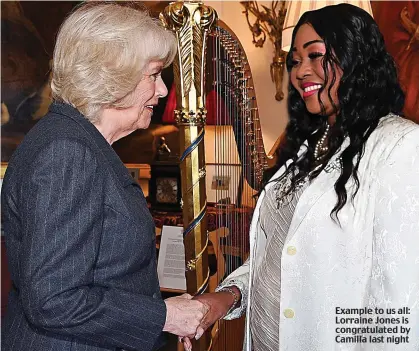  ??  ?? Example to us all: Lorraine Jones is congratula­ted by Camilla last night