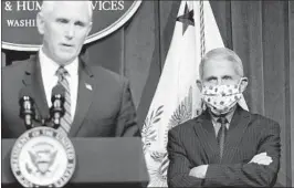  ?? JOSHUA ROBERTS/GETTY ?? Dr. Anthony Fauci watches as Vice President Mike Pence speaks at a briefing Friday.