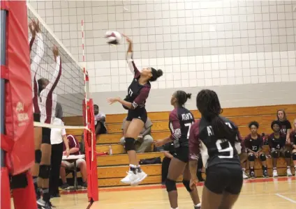  ?? Staff photo byJosh Richert ?? ■ Atlanta’s Dyamond Grant goes high for an attack against Liberty-Eylau during the season-opening match between the teams Tuesday at Liberty-Eylau Middle School.