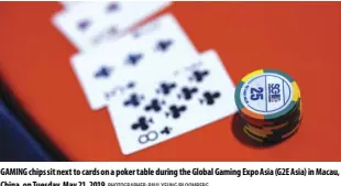  ?? Photograph­er: Paul Yeung/bloomberg ?? Gaming chips sit next to cards on a poker table during the Global Gaming Expo asia (G2E asia) in macau, China, on Tuesday, may 21, 2019.