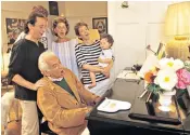  ??  ?? A boy like that: Bernstein surrounded by his family at his Connecticu­t home in 1986, left; in 1955, right, and his most famous work, West Side Story, below