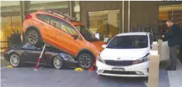  ?? REUTERSPIX ?? ... A valet at Sydney’s Hyatt Regency hotel had a bad day at work yesterday after he accidental­ly parked a Porsche Carrera underneath another vehicle. While attempting to park the Porsche, the car reportedly accelerate­d and ended up under the SUV. The...