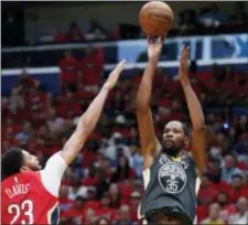  ?? GERALD HERBERT — THE ASSOCIATED PRESS ?? Golden State Warriors forward Kevin Durant (35) shoots against New Orleans Pelicans forward Anthony Davis (23) in the first half of Game 4.