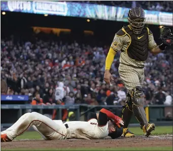  ?? JEFF CHIU — THE ASSOCIATED PRESS ?? San Francisco Giants’ Blake Sabol, bottom, reacts after scoring against San Diego Padres catcher Gary Sanchez during the fifth inning on Wednesday. Sabol was initially called out but was ruled safe after the Giants challenged.