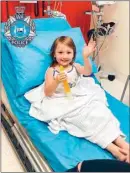  ?? WESTERN AUSTRALIA POLICE VIA AP ?? Four-year-old Cleo Smith waves as she sits on a bed in a hospital on Wednesday in Carnarvon, western Australia. Police smashed their way into a suburban house on Wednesday and rescued Cleo, whose disappeara­nce from her family’s camping tent on Australia’s remote west coast more than two weeks ago both horrified and captivated the nation. The seal of Western Australia Police is seen at top left.