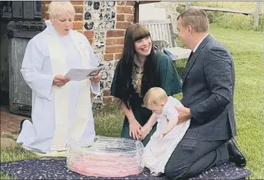  ??  ?? CREATIVE The Rev Vickie Morgan, left, baptises Ivy in a paddling pool with Lauren and Stuart Floyd