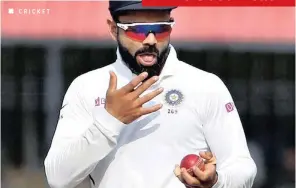  ?? AIJAZ RAHI AP ?? INDIA’S captain
Virat Kohli shines the ball during a cricket test match.
|