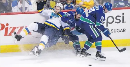  ?? — THE CANADIAN PRESS FILES ?? Sam Gagner, right, knows how to provide defensive support, like when Erik Gudbranson collided with St. Louis Blues’ Joel Edmundson, left, Saturday at Rogers Arena.