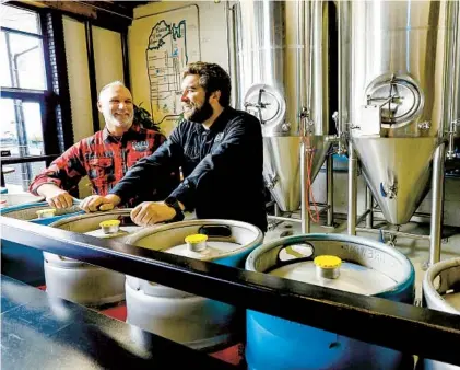  ?? JOHN GASTALDO PHOTOS FOR THE U-T ?? Joel Steinmetz (left) and Trevor Whitehead are co-founders of South O Brewing, located on Coast Highway.