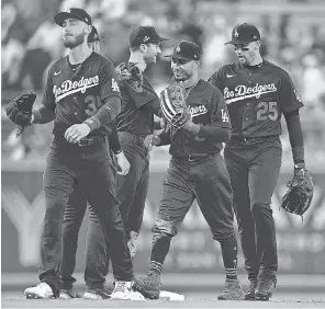  ?? GARY A. VASQUEZ/ USA TODAY SPORTS ?? Dodgers players celebrate a win against the Giants at Dodger Stadium and have overtaken the Astros in the power rankings.