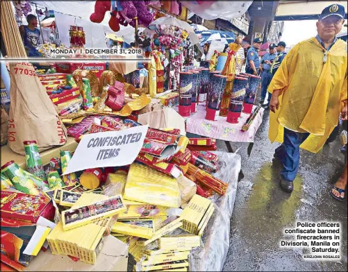  ?? KRIZJOHN ROSALES ?? Police officers confiscate banned firecracke­rs in Divisoria, Manila on Saturday.