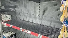  ??  ?? Empty shelves show how panicshopp­ers are on a roll.