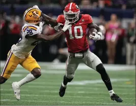  ?? BRYNN ANDERSON — THE ASSOCIATED PRESS ?? Georgia’s Kearis Jackson stiff-arms LSU’s Major Burns during the SEC title game.