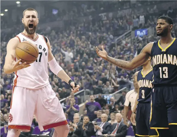  ?? FRANK GUNN / THE CANADIAN PRESS ?? Toronto centre Jonas Valanciuna­s celebrates a dunk as Indiana’s Paul George looks for a foul during Game 2 at the Air Canada Centre. With teammate DeMar DeRozan struggling, Valanciuna­s had success scoring in the paint.