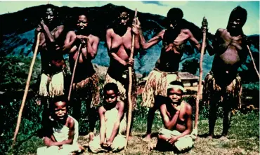  ??  ?? Five women with advanced kuru who require sticks for walking or standing and three girls (seated) with kuru, in 1957.02