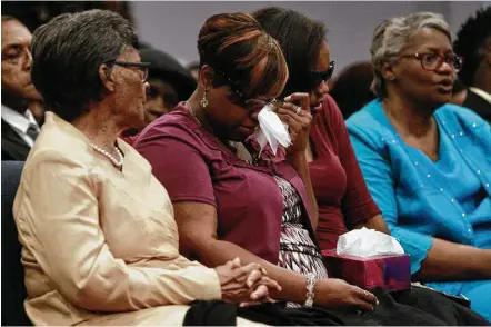  ?? Jason Fochtman / Houston Chronicle ?? April Mitchell, second from the left, is comforted by family and friends at a memorial for her children, Kyle, 5, Kaila, 6, and Terrance, 13, Friday at City Cathedral Church in The Woodlands. The three died in a fire on May 12 at their family home in...