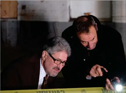  ?? JAKE VITALI — SENTINEL & ENTERPRISE ?? Aldo Mazzaferro and Fitchburg Mayor Stephen Dinatale peer past caution tape inside the former Iver Johnson Arms and Cycle Works manufactur­ing facility on River Street in Fitchburg on Monday, March 6, 2023. Mazzaferro and partner Rich Darche are set to transform abandoned structure into “high-quality” housing — both thanked Dinatale and the city for their cooperatio­n and support of the project.
