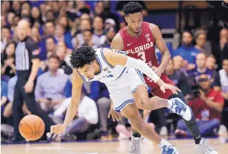  ?? GERRY BROOME/ASSOCIATED PRESS ?? Duke guard Tre Jones, left, chases the ball with Florida State guard Trent Forrest during the first half. Jones scored 13 points to help lead the No. 7 Blue Devils to a 70-65 win over the No. 8 Seminoles.