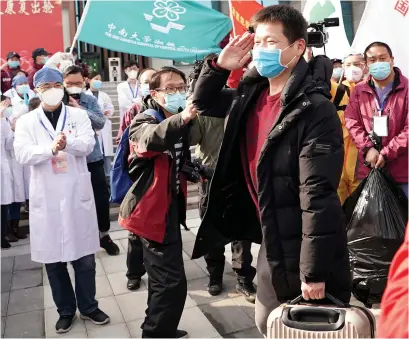  ?? Pictures: AVALON RED / EPA ?? Good reason to cheer... the last patient leaves the only remaining temporary hospital in Wuhan yesterday