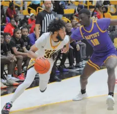  ?? (Special to the Commercial/William Harvey) ?? UAPB guard Joe French dribbles past Arkansas Baptist defender Makhai Helsey during a Nov. 27 basketball game at H.O. Clemmons Arena in Pine Bluff.