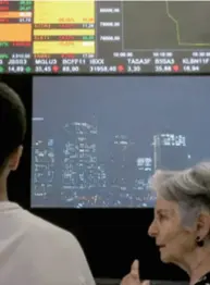  ??  ?? Investors look at an electronic board at the B3 Stock Exchange in Sao Paulo, Brazil, on March 12. Brazilian stocks plummeted recently amid the oil price war and fears of the global COVID-19 pandemic