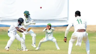  ?? PHOTO BY LENNOX ALDRED ?? CCC batsman Jonathan Carter (left) cuts off-spinner Peat Salmon (right) for runs during their West Indies Championsh­ip match against the Jamaica Scorpions at Sabina Park yesterday. Looking on are wicket-keeper Romaine Morris (second left) and captain Jermaine Blackwood.