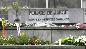  ??  ?? Flowers are laid in front of Liege police headquarte­rs in tribute for the vicitms of a shooting in Liege. — AFP photo