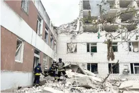  ?? HANDOUT/UKRAINIAN EMERGENCY SERVICE/AFP ?? Ukrainian rescuers working at the site of a missile attack in Chernigiv, amid the Russian invasion of Ukraine. PHOTO: