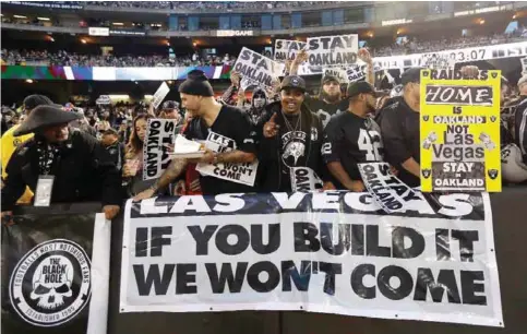  ??  ?? OAKLAND: In this Nov 6, 2016, file photo, Oakland Raiders fans hold up signs about the team’s possible move to Las Vegas during an NFL football game between the Raiders and the Denver Broncos. — AP