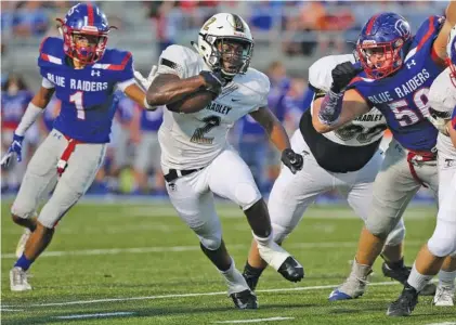  ?? STAFF PHOTO BY ERIN O. SMITH ?? Bradley Central running back Ricky McCleary (2) finds a hole during the first half of Bradley Central’s game at crosstown rival Cleveland on Friday. McCleary scored four touchdowns in the Bears’ 32-14 win.