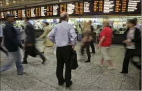  ?? RICHARD DREW — THE ASSOCIATED PRESS ?? In this July 15, 2014, file photo, a man consults the Long Island Rail Road departure board amid morning commuters, in New York’s Penn Station. Some frustrated Long Island Rail Road riders are suing the Metropolit­an Transporta­tion Authority, the LIRR’s...