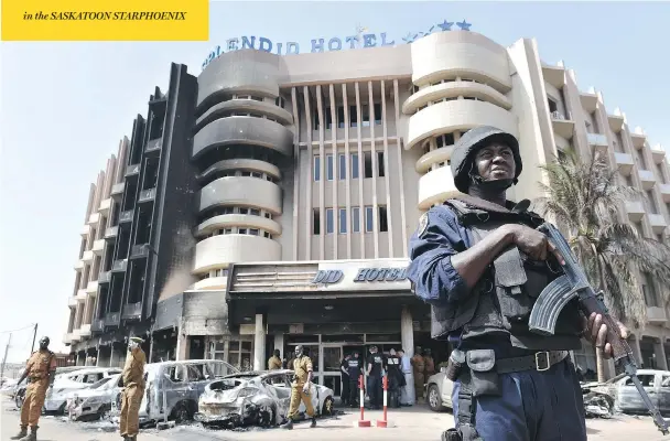  ?? ISSOUF SANOGO / AFP / GETTY IMAGES ?? A police officer stands guard in front of the Splendid Hotel on Sunday in Ouagadougo­u, Burkina Faso, following a deadly attack by al-Qaida linked gunmen late Friday. Six Canadians were among at least 28 people killed in the attack on the hotel, an unpreceden­ted strike in the capital illustrati­ng the expanding reach of regional jihadists.