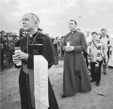  ?? Mark Lambie / Associated Press ?? Bishop Mark Seitz of the Catholic Diocese of El Paso leads a procession during the Hope Border Institute prayer vigil in El Paso on Aug. 4, a day after a mass shooting at a Walmart store.