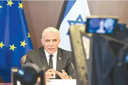  ?? (Kobi Gideon/GPO) ?? PRIME MINISTER Yair Lapid speaks in a video call from Israel with representa­tives of the European Union, on Monday.