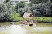  ?? DAVID BEBEE WATERLOO REGION RECORD ?? The model of a floating home sits in the middle of a retention pond at the University of Waterloo. UW professors are developing retrofits to allow houses to float in flood zones.