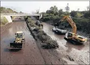  ??  ?? CALTRANS WORKERS continue to remove muck from a two-mile stretch of Highway 101 on Friday.
