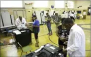  ?? KIMBERLY P. MITCHELL — DETROIT FREE PRESS VIA ASSOCIATED PRESS ?? Detroit voters cast their vote in the Michigan primaries at Pasteur Elementary in Detroit on Tuesday, Aug. 7, 2018.