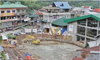  ??  ?? PARKING SITE — Shown here is the exact spot at the town center of Banaue, Ifugao, where the six-storey parking building project is being built. Mayor Jerry Dalipog says it won’t destroy the view of the world-famous Banaue Rice Terraces. (Zaldy Comanda)