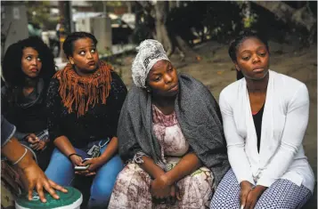  ?? Photos by Sarah Rice / Special to The Chronicle ?? Pineal Anulo (left), Meheret Anulo, Nadege Nadege and Annick Seri attend a Sept. 13 vigil for Yonas Alehegne, who was shot dead by an Oakland police officer after he bludgeoned her with a chain.