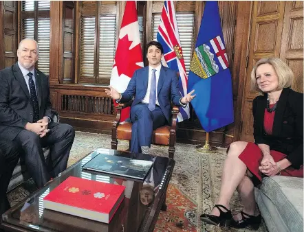  ?? — THE CANADIAN PRESS ?? Premier John Horgan, left, continued to oppose the Kinder Morgan pipeline expansion Sunday after his meeting with Prime Minister Justin Trudeau and Alberta Premier Rachel Notley.