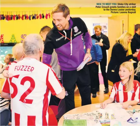  ??  ?? NICE TO MEET YOU: Stoke City striker Peter Crouch greets families on a visit to the Donna Louise yesterday. Picture: Leanne Bagnall