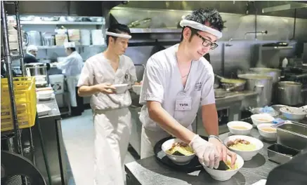  ?? Christina House For The Times ?? CHEFS Tomotsugu Kubo, left, and Yuta Soma prepare ramen at Tsujita, a branch of a well-regarded Tokyo noodle shop, in Glendale.