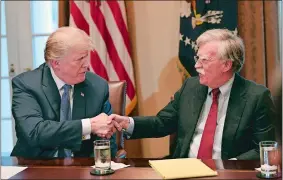  ?? SUSAN WALSH/AP PHOTO ?? President Donald Trump shakes hands with his new national security adviser, John Bolton, in the Cabinet Room of the White House on Monday at the start of a meeting with military leaders.