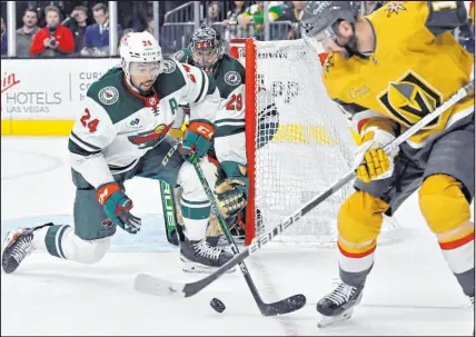  ?? ?? The Wild’s Matt Dumba defends against Knights center Nicolas Roy in front of goalkeeper Marcandre Fleury. Fleury made 39 saves, while the Knights’ Laurent Brossoit stopped 29 shots.