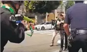  ?? LAPD ?? POLICE body-camera video shows an officer pushing protester Ben Montemayor and shooting him in the groin with a hard foam projectile last summer.