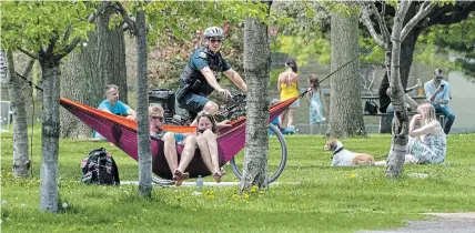  ?? FRANK GUNN THE CANADIAN PRESS ?? A police officer patrols Trinity Bellwoods Park in Toronto on Sunday. Thousands at the park Saturday were not physical distancing.