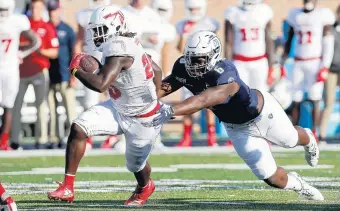  ?? KAITLIN MCKEOWN/STAFF FILE ?? Old Dominion’s Keion White, right, goes for a tackle against Florida Atlantic’s Malcolm Davidson on Oct. 26. White finished fourth in Conference USA in tackles for loss per game (1.58) and was voted second-team all-conference.