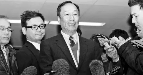  ??  ?? Gou, chairman of Foxconn Technology Group, speaks at Sharp headquarte­rs in Osaka, Japan, on Feb 5, as Foxconn took a step forward in the hotly contested battle for control of Sharp. — WP-Bloomberg photo