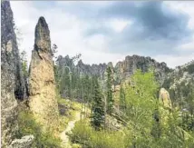  ?? Deb Hopewell ?? GRANITE “needles” pierce the sky along the Peter Norbeck Scenic Byway, which winds through Custer State Park.